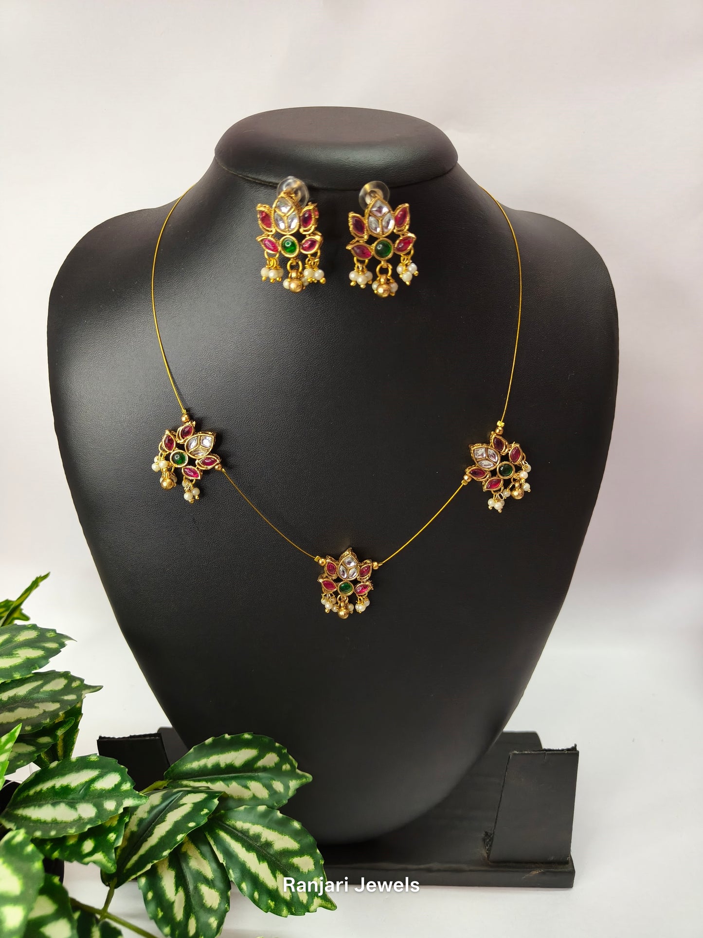 Varshika – Lotus Design Kemp Stone Invisible Chain Set